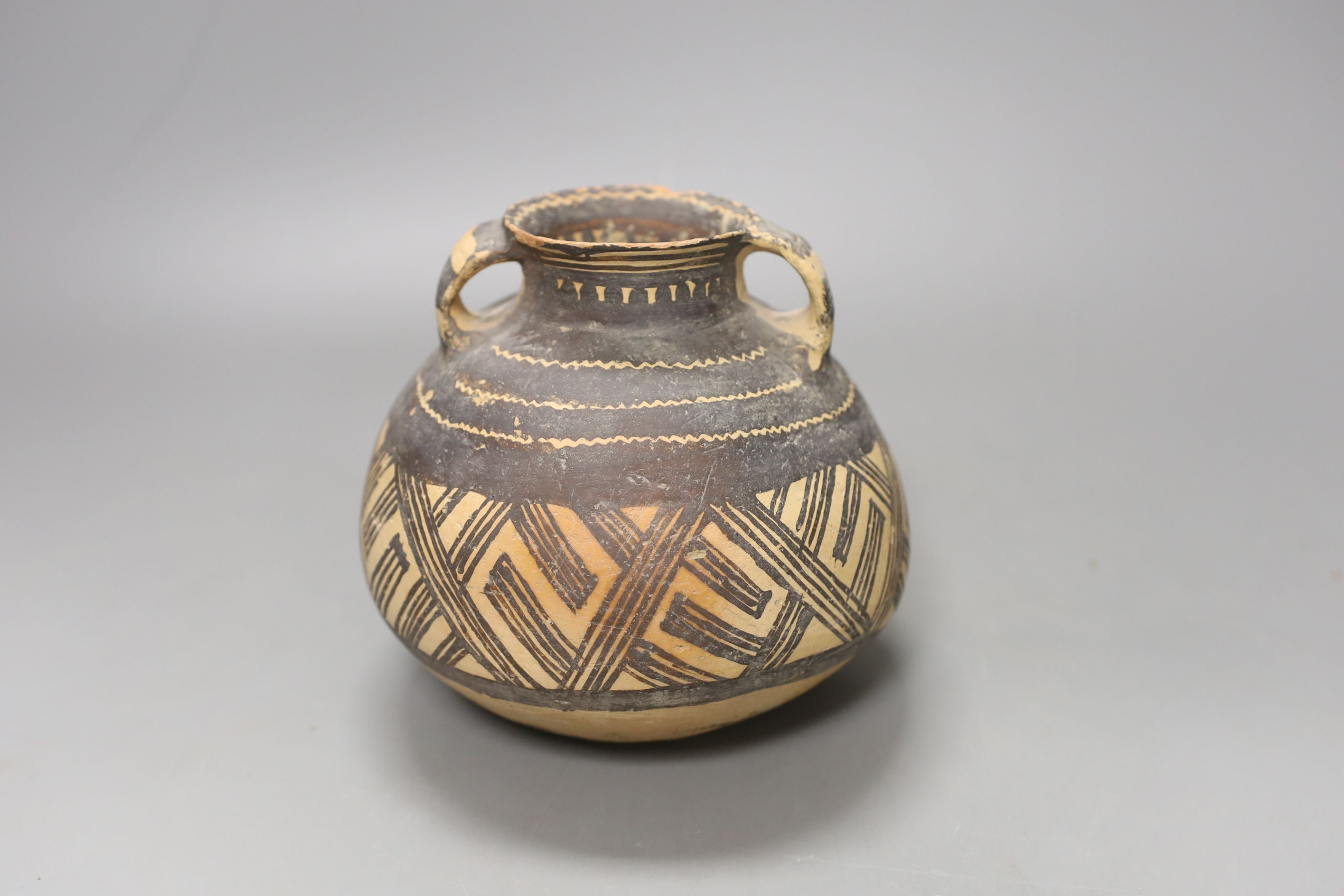 A Chinese neolithic pottery two handled jar - 14cm tall